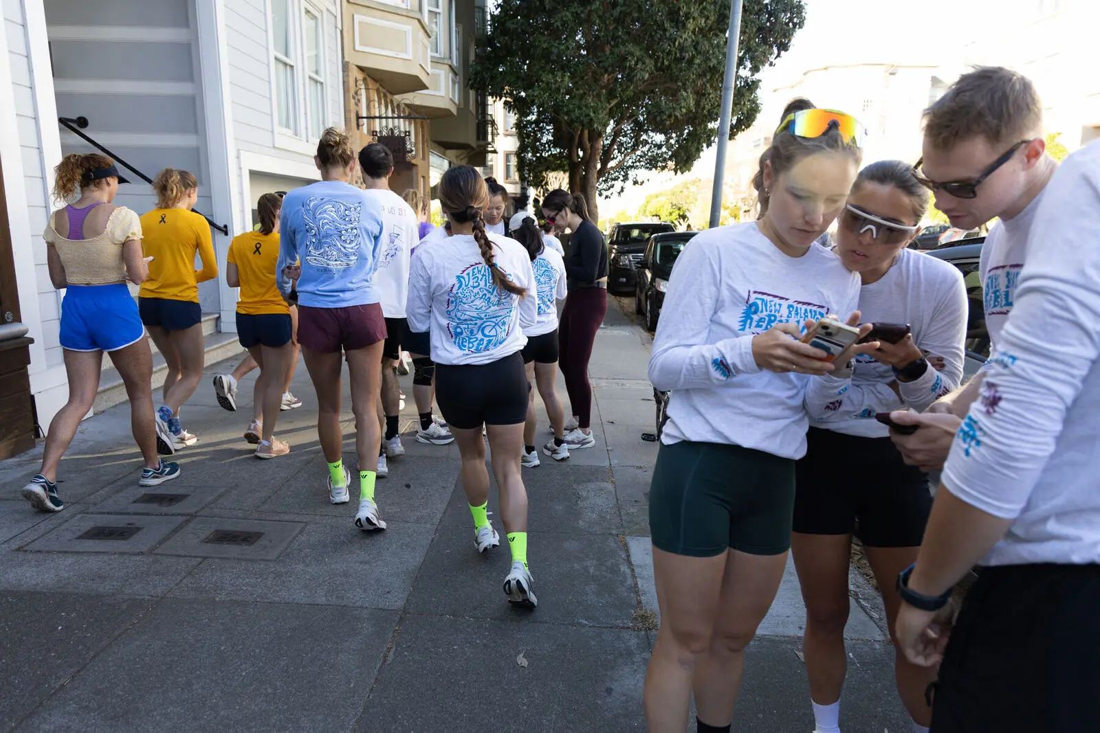 Teammates huddled over a phone, working out a clue
