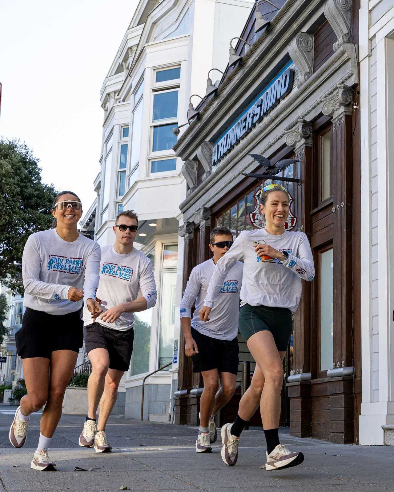 A team running past the A Runner's Mind storefront